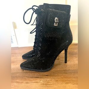 Sparkly black heeled boots by Jennifer Lopez.